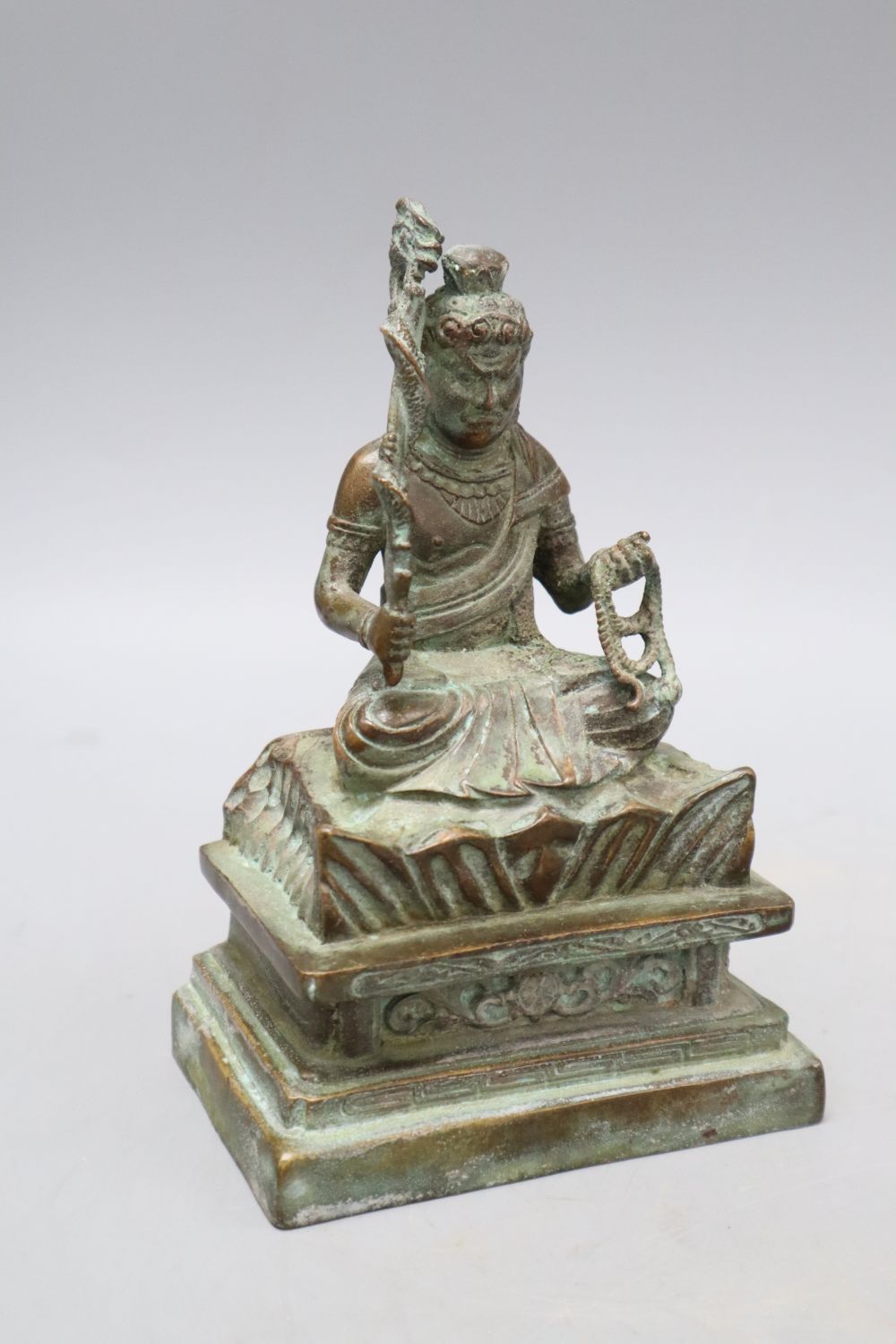 A Himalayan bronze seated figure of a deity, height 16cm